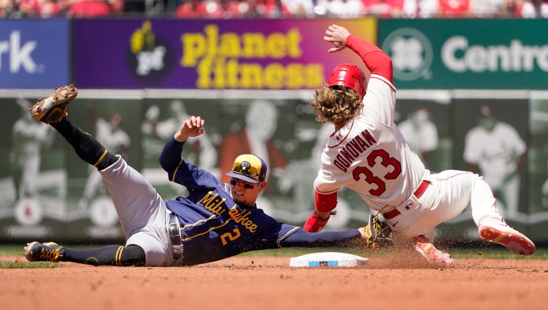 St. Louis Cardinals' Brendan Donovan (33) is tagged out at second by Milwaukee Brewers shortstop Luis Urias (2) on a failed stolen base attempt during the third inning of a baseball game Saturday, May 28, 2022, in St. Louis.