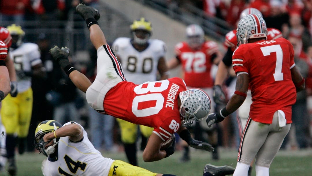 FILE - In this Nov. 18, 2006, file photo, Ohio State wide receiver Brian Robiskie (80) and Michigan cornerback Morgan Trent (14) collide during a college football game in Columbus, Ohio. Ahead of the college football season, The Associated Press asked its panel of voters in the Top 25 poll on the nation's best rivalries. Ohio State-Michigan was No. 2.