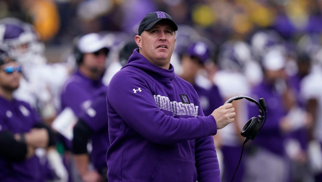 Northwestern head coach Pat Fitzgerald watches from the sideline during the first half of an NCAA college football game against Michigan, Saturday, Oct. 23, 2021, in Ann Arbor, Mich.