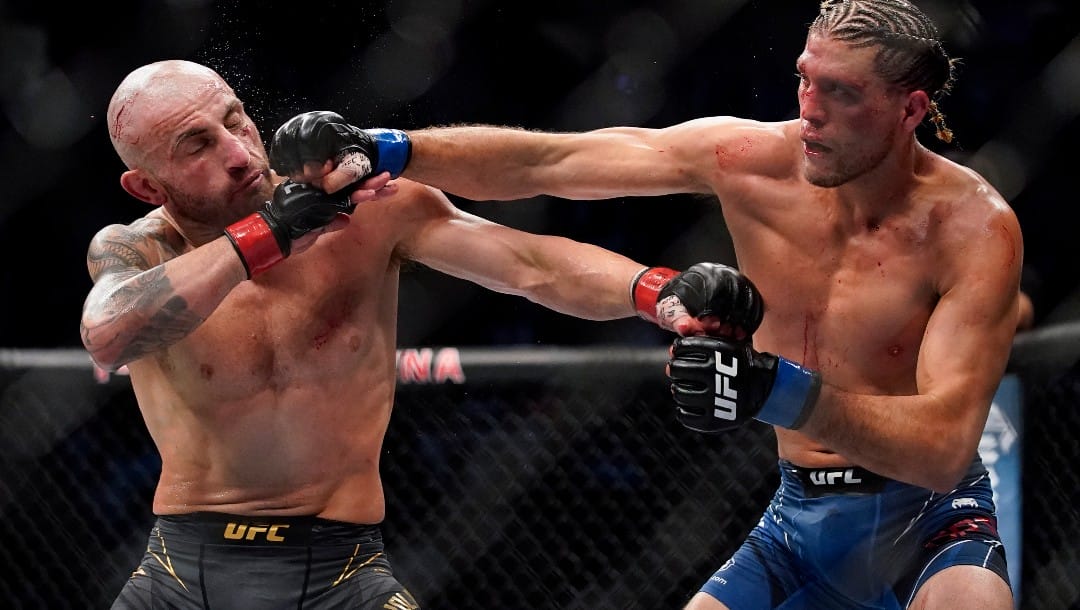 Alexander Volkanovski, left, fights Brian Ortega during a featherweight mixed martial arts title bout at UFC 266.