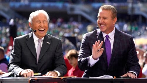 Kirk Herbstreit, right, shares a laugh with Lee Corso on the set of ESPN's College Game Day program in Soldier Field before an NCAA college football game between Wisconsin and Notre Dame Saturday, Sept. 25, 2021, in Chicago. (AP Photo/Charles Rex Arbogast)