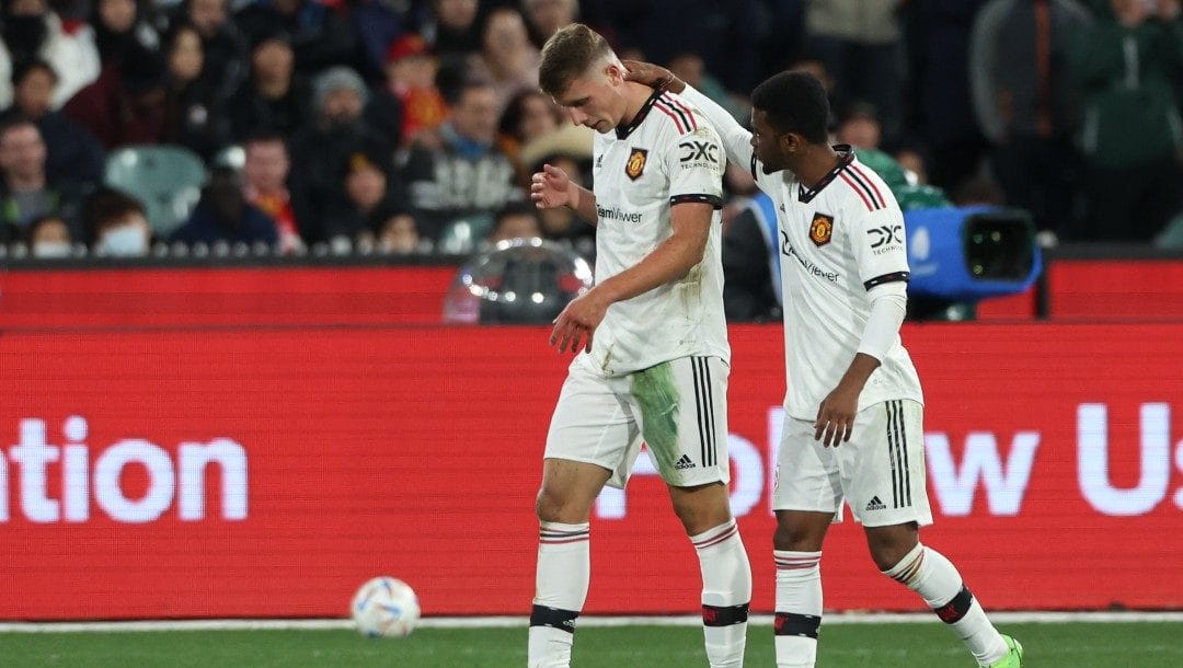 Manchester United's Amad Diallo, right, consoles teammate Will Fish after he was sent off during a pre-season game between Manchester United and Crystal Palace at the Melbourne Cricket Ground in Melbourne, Australia, Tuesday, July 19, 2022.