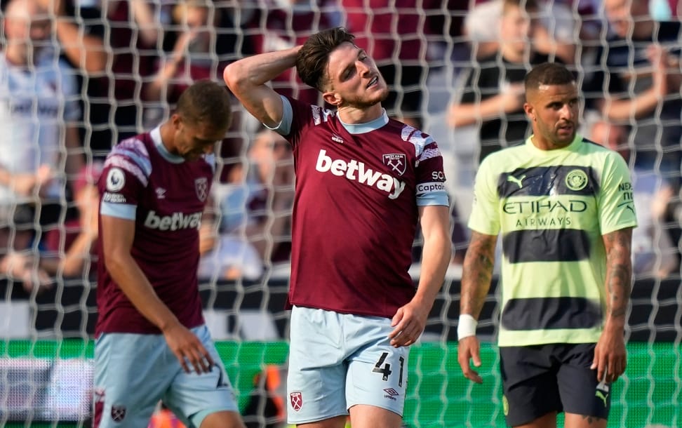 West Ham's Declan Rice grimaces during the English Premier League soccer match between West Ham United and Manchester City at the London Stadium in London, England, Sunday, Aug. 7, 2022.