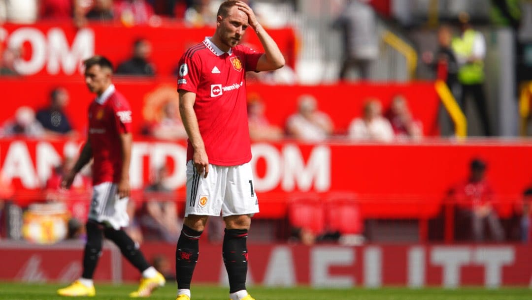 Man Utd player Christian Eriksen holds his head during the EPL game against Brighton.