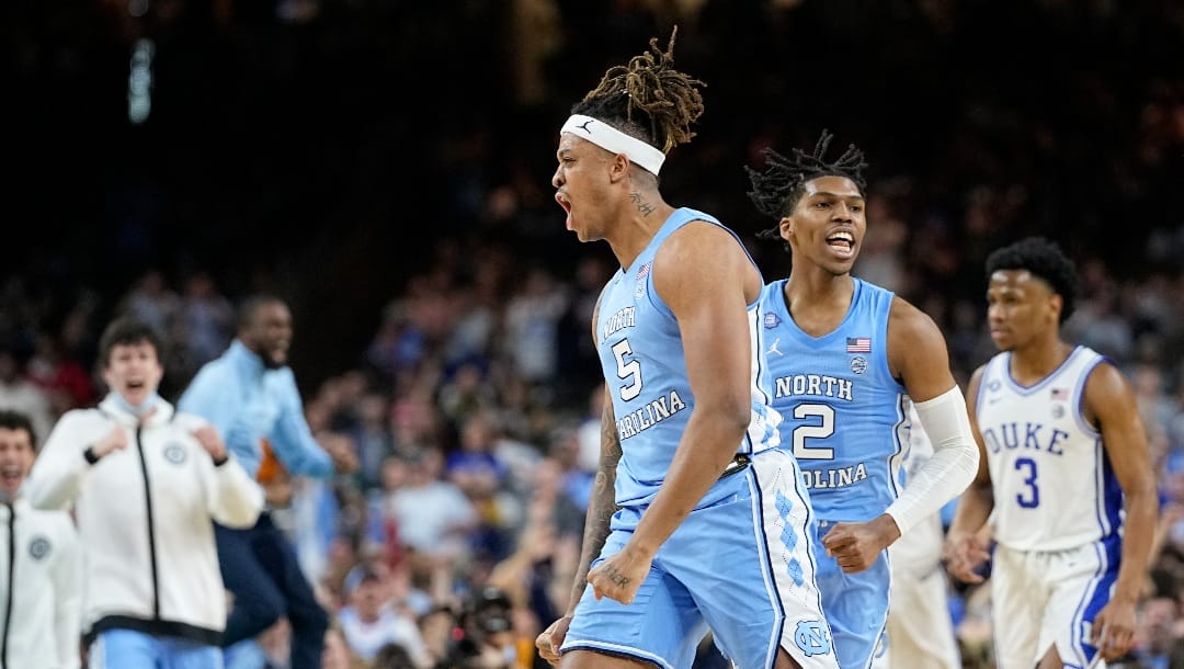North Carolina forward Armando Bacot (5) and guard Caleb Love (2) celebrate after a score during the second half of a college basketball game against Duke in the semifinal round of the Men's Final Four NCAA tournament, Saturday, April 2, 2022, in New Orleans. (AP Photo/David J. Phillip)