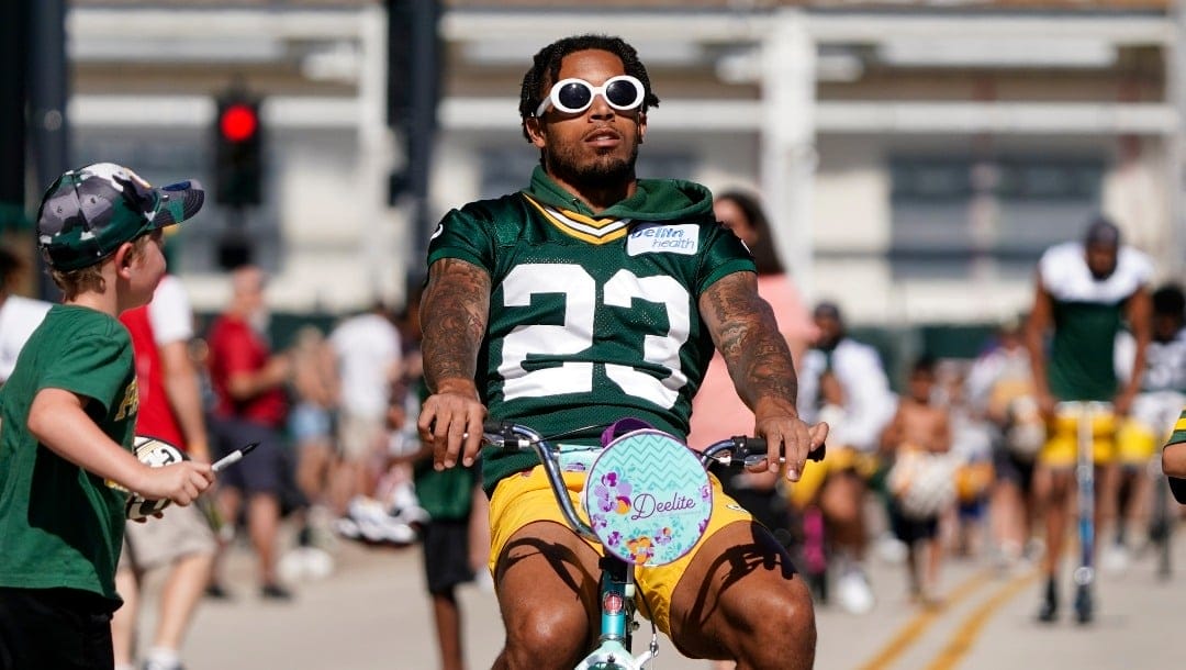 Green Bay Packers' Jaire Alexander rides a bike to the NFL football team's practice field Saturday, July 30, 2022, in Green Bay, Wis. (AP Photo/Morry Gash)