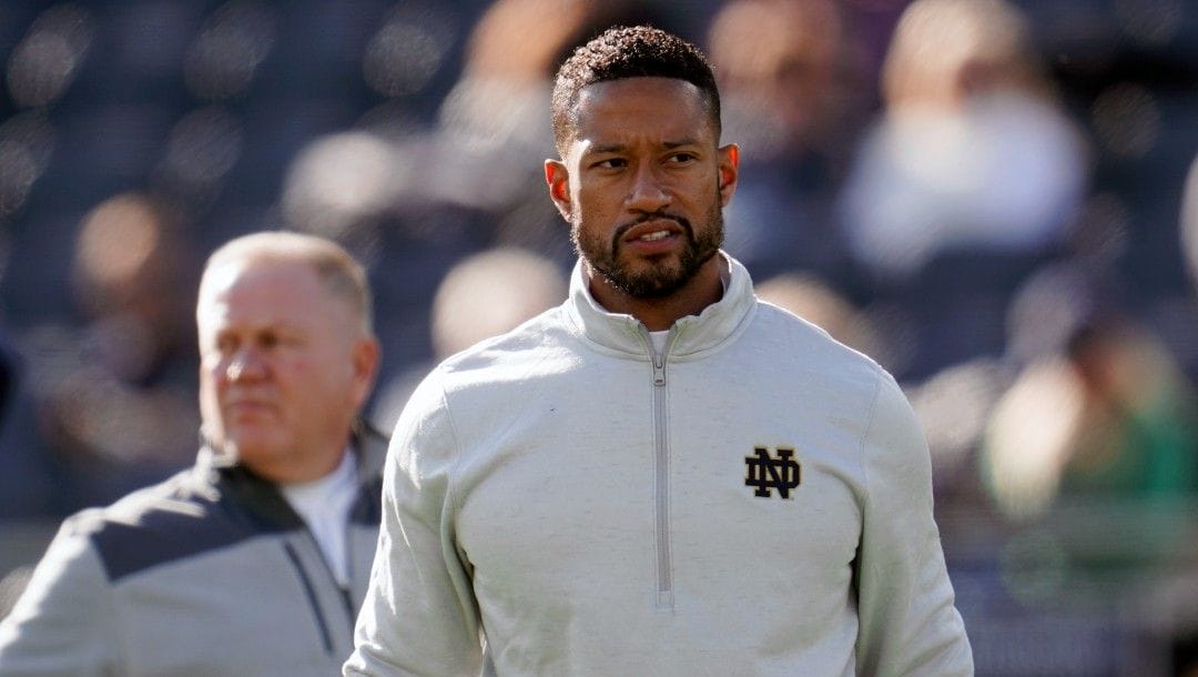 Notre Dame defensive coordinator Marcus Freeman watches during warmups before an NCAA college football game against Navy in South Bend, Ind., Saturday, Nov. 6, 2021.