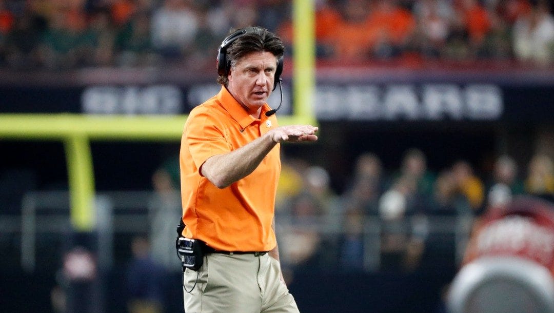 Oklahoma State head coach Mike Gundy watches play from the sideline during the first half of the Big 12 Championship NCAA college football game against Baylor in Arlington, Texas, Saturday, Dec. 4, 2021.