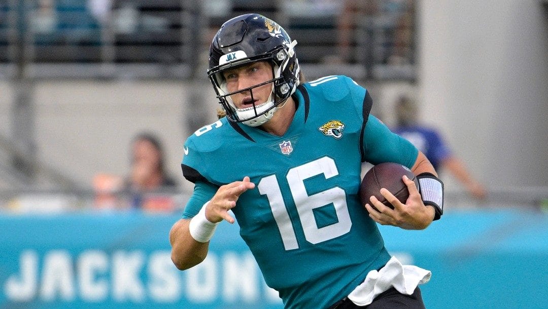 Jacksonville Jaguars quarterback Trevor Lawrence (16) scrambles for yardage during the first half of a preseason NFL football game against the Cleveland Browns, Friday, Aug. 12, 2022, in Jacksonville, Fla.