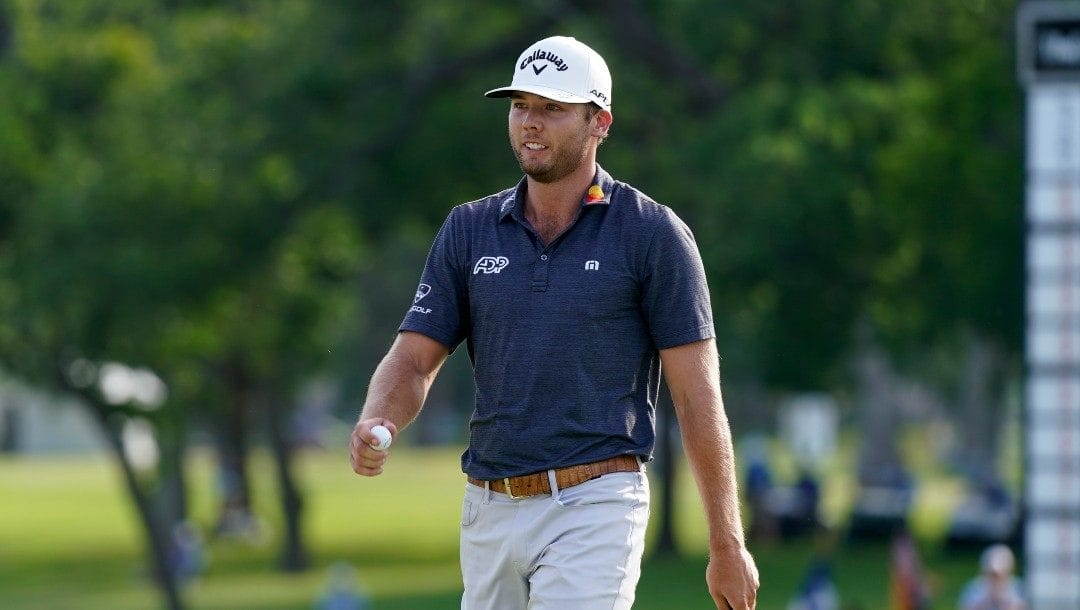 Sam Burns walks after sinking a putt on the 18th hole during a playoff in the final round of the Charles Schwab Challenge golf tournament at the Colonial Country Club in Fort Worth, Texas, Sunday, May 29, 2022.