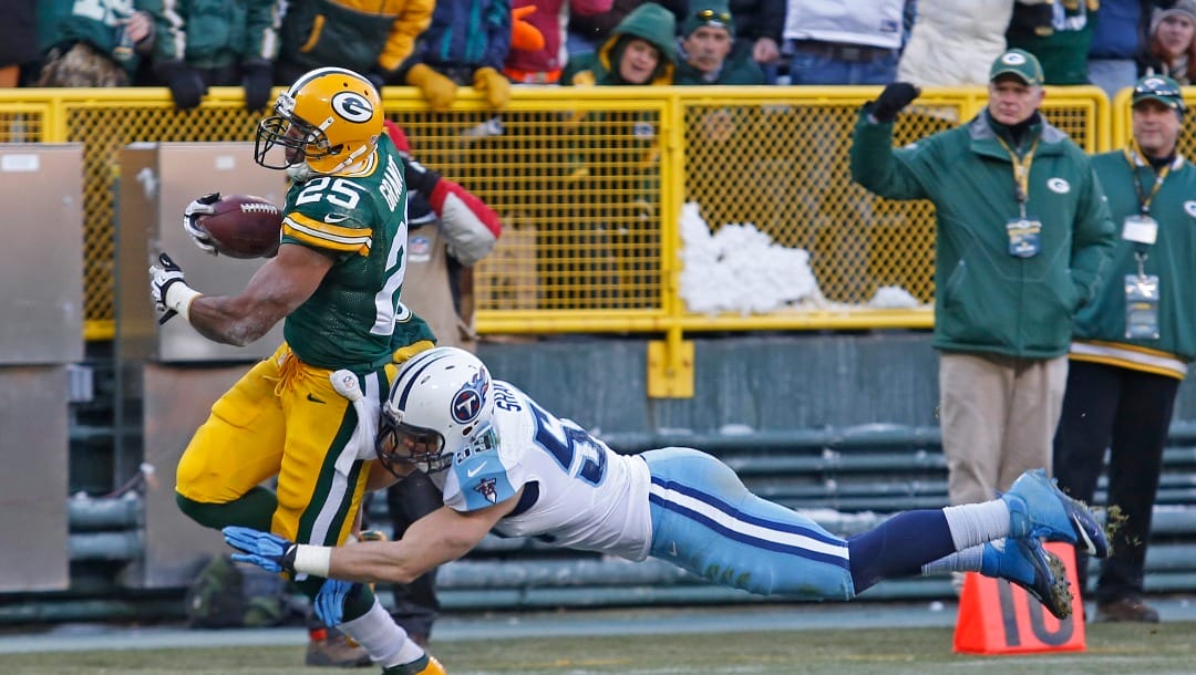 Green Bay Packers running back Ryan Grant is hit during a play by Tennessee Titans middle linebacker Tim Shaw during an NFL football game Sunday, Dec. 23, 2012, in Green Bay, Wis. (AP Photo/Matt Ludtke)