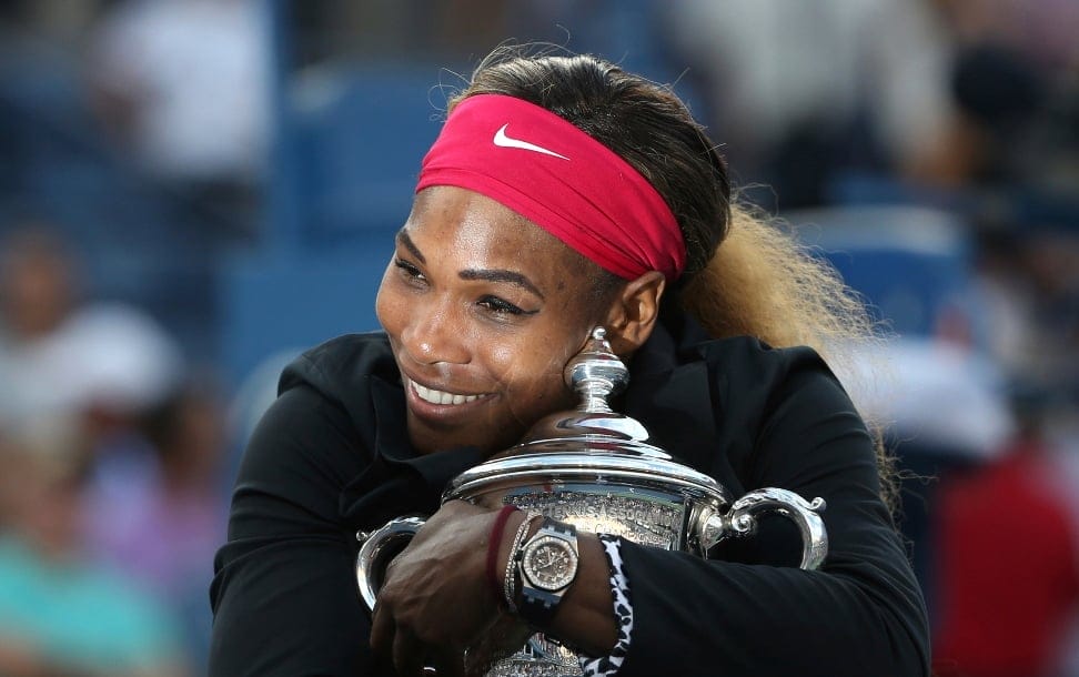Serena Williams, of the United States, hugs the championship trophy after defeating Caroline Wozniacki, of Denmark, during the championship match of the 2014 U.S. Open