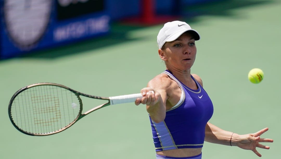 Romania's Simona Halep returns during a first round match against Spain's Cristina Bucsa at the Citi Open tennis tournament in Washington, Monday, Aug. 1, 2022.