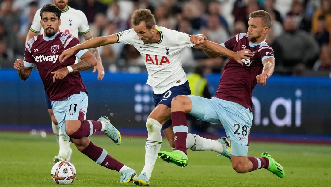 Tottenham's Harry Kane, center, and West Ham's Lucas Paqueta, left, and West Ham's Tomas Soucek vie for the ball during the English Premier League soccer match between West Ham and Tottenham, at London Stadium, in London, Wednesday, Aug. 31, 2022. (AP Photo/Frank Augstein)