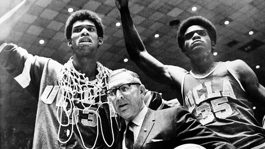FILE - In this March 24, 1969, file photo, UCLA coach John Wooden is flanked by Sidney Wicks, right, and Lew Alcindor, draped with basket ropes, after the UCLA team beat Purdue 92-72 to win the NCAA basketball title for the third consecutive year, in Louisville, Ky. (AP Photo, File)