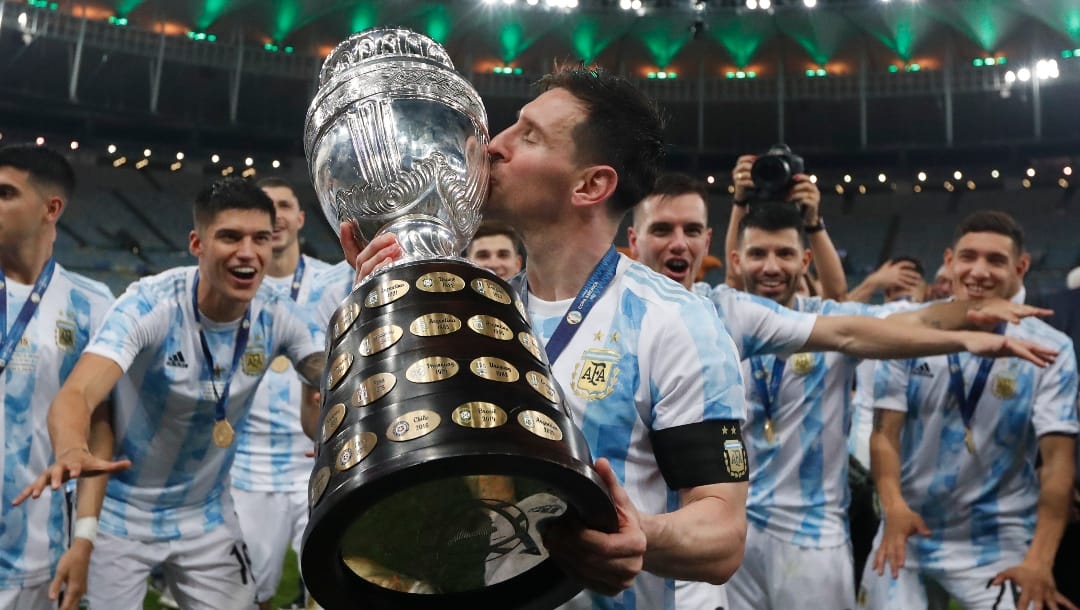Argentina's Lionel Messi kisses the trophy after beating Brazil 1-0 in the Copa America final soccer match at Maracana stadium in Rio de Janeiro, Brazil, Saturday, July 10, 2021.