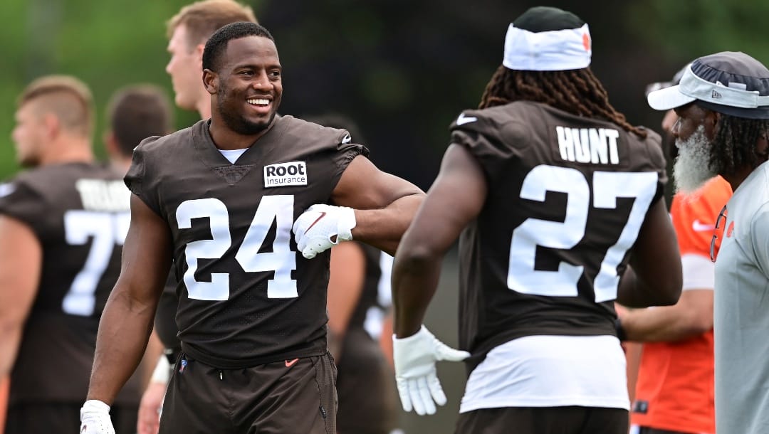Cleveland Browns running back Nick Chubb, left, talks with running back Kareem Hunt during an NFL football practice in Berea, Ohio, Sunday, Aug. 7, 2022. (AP Photo/David Dermer)