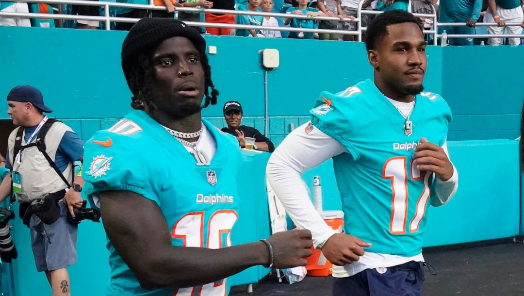 Miami Dolphins wide receiver Tyreek Hill (10) and wide receiver Jaylen Waddle (17) head out to the field before the start of a NFL preseason football game against the Las Vegas Raiders, Saturday, Aug. 20, 2022, in Miami Gardens, Fla. (AP Photo/Wilfredo Lee)
