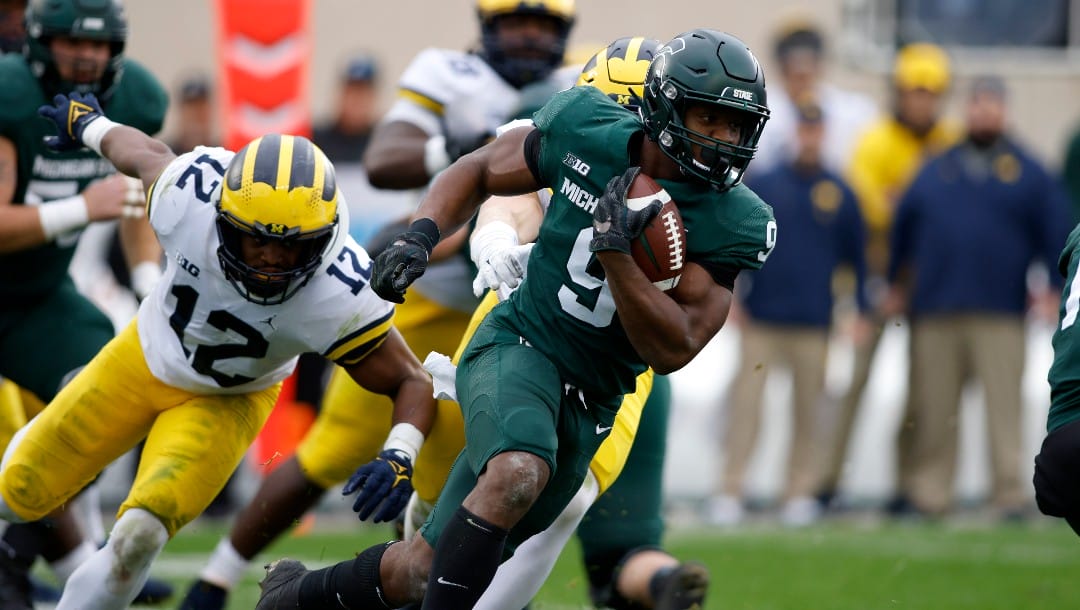 Michigan State's Kenneth Walker III (9) runs against Michigan during an NCAA college football game, Saturday, Oct. 30, 2021, in East Lansing, Mich. (AP Photo/Al Goldis)