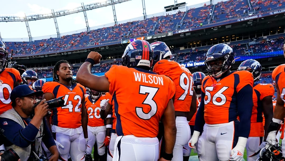Denver Broncos quarterback Russell Wilson (3) talks with his team prior to an NFL preseason football game against the Minnesota Vikings, Saturday, Aug. 27, 2022, in Denver. (AP Photo/Jack Dempsey)