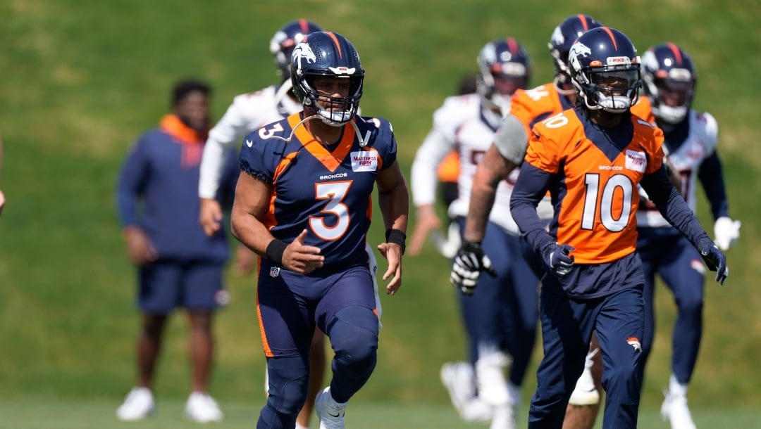 Denver Broncos quarterback Russell Wilson and wide receiver Jerry Jeudy takes part in drills at the NFL football team's voluntary veteran minicamp Wednesday, April 27, 2022, at the team's headquarters in Englewood, Colo. (AP Photo/David Zalubowski)