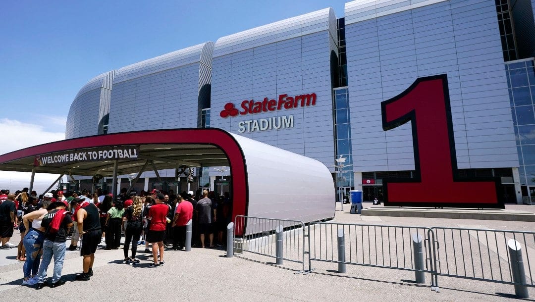 Arizona Cardinals fans line up prior to watching practice at the NFL football team's training camp at State Farm Stadium, Saturday, July 30, 2022, in Glendale, Ariz. (AP Photo/Ross D. Franklin)