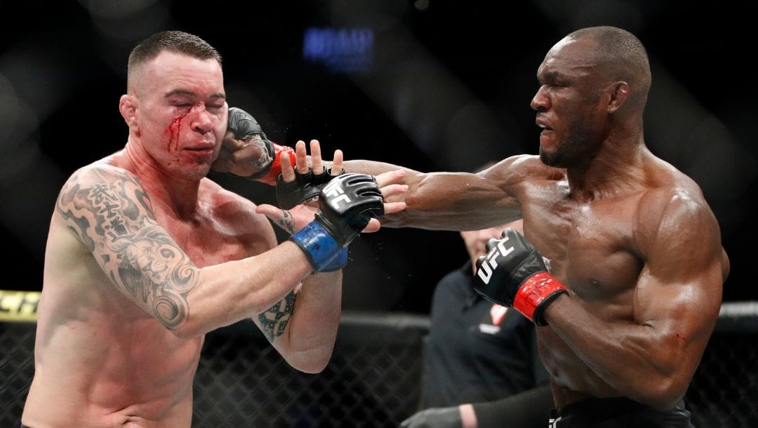 Kamaru Usman hits Colby Covington in a mixed martial arts welterweight championship bout at UFC 245, Saturday, Dec. 14, 2019.