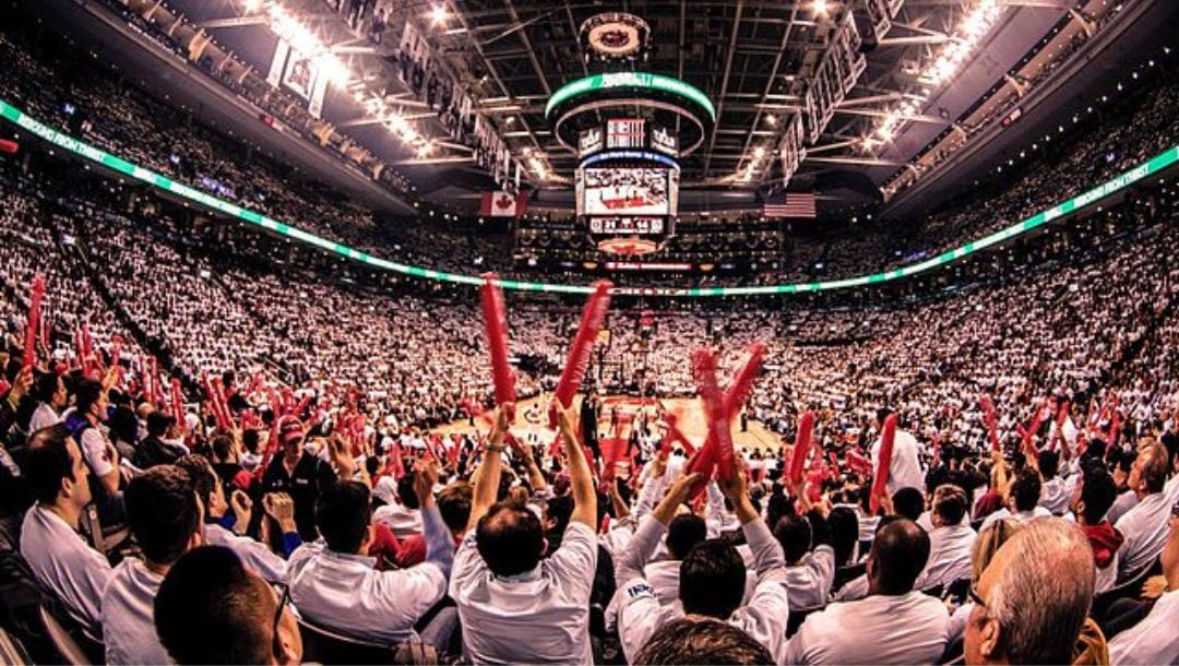 Thousands of fans cheer for the Toronto Raptors inside their home arena during an NBA game.