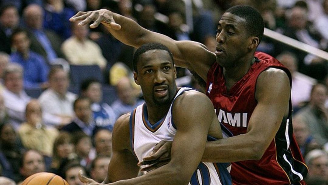 Gilbert Arenas of the Washington Wizards NBA team drives with the basketball while Eddie Jones of the Miami Heat defends.