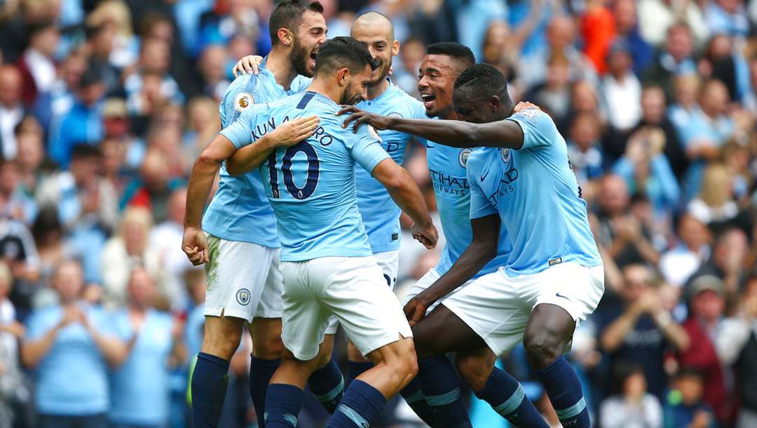 Manchester City's Sergio Aguero, left, celebrates with team mates after scoring his side's first goal of the game during the English Premier League.