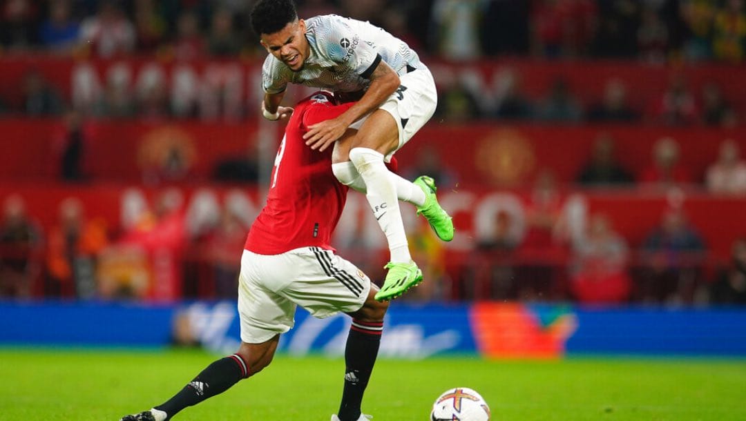 Liverpool's Luis Diaz, right, is fouled by Manchester United's Raphael Varane