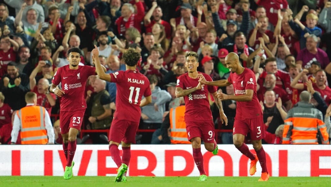 Liverpool's Roberto Firmino, second right, celebrates after scoring his sides first goal during the English Premier League soccer match .