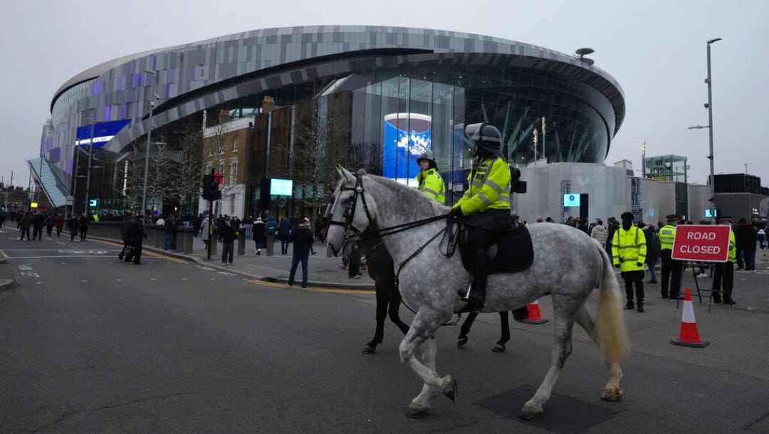 Police officers patrol outside of the Tottenham Hotspur Stadium .