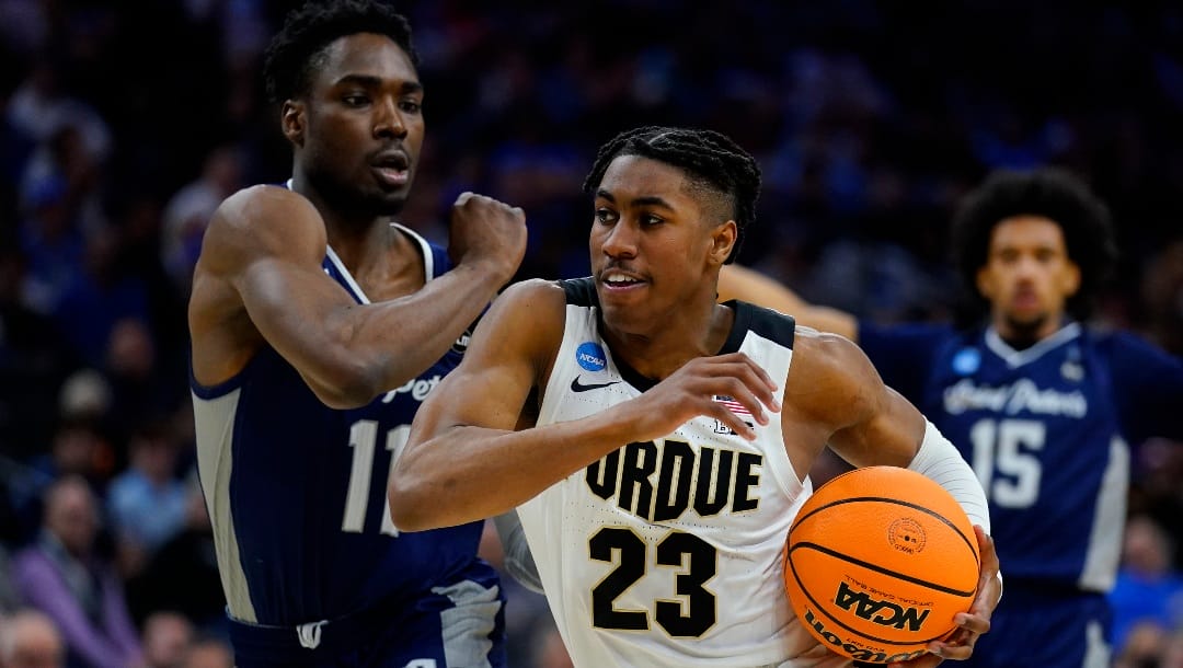 Purdue's Jaden Ivey (23) drives past Saint Peter's KC Ndefo (11) during the second half of a college basketball game in the Sweet 16 round of the NCAA tournament, Friday, March 25, 2022, in Philadelphia.