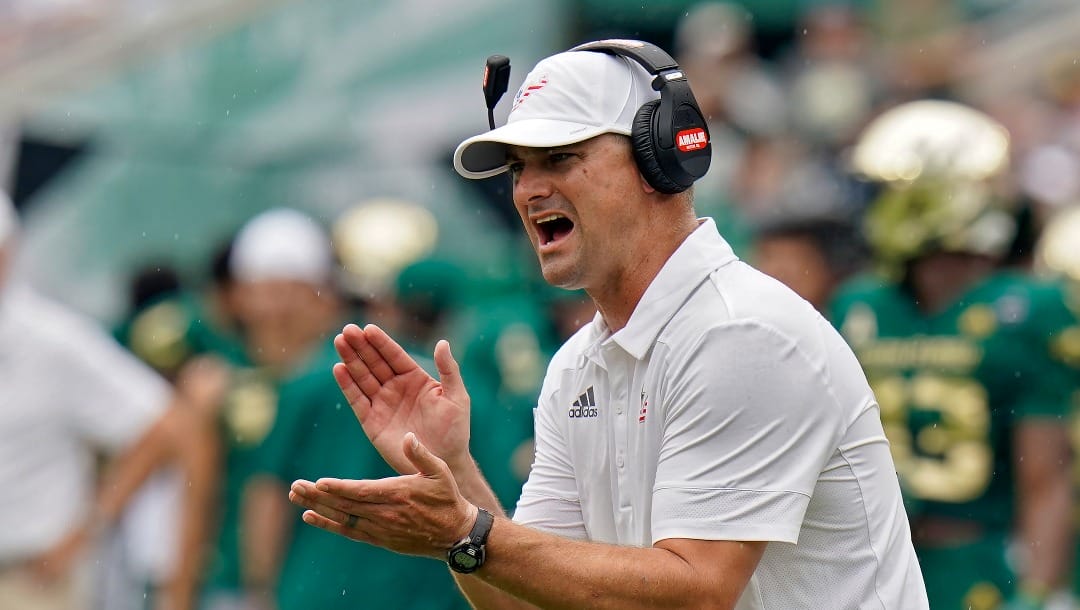 FILE - South Florida head coach Jeff Scott tries to fire up his team during the first half of an NCAA college football game against Florida, Saturday, Sept. 11, 2021, in Tampa, Fla. South Florida plays BYU on Saturday, Sept. 3, 2022. (AP Photo/Chris O'Meara)