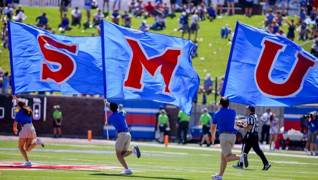 SMU flags are run across the field during a time out in the second half of an NCAA college game against TCU on Saturday, Sept. 24, 2022, in Dallas, Texas.