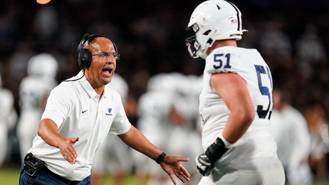 Penn State head coach James Franklin, left, greets Jimmy Christ (51) following a touchdown against Purdue during the first half of an NCAA college football game in West Lafayette, Ind., Thursday, Sept. 1, 2022.
