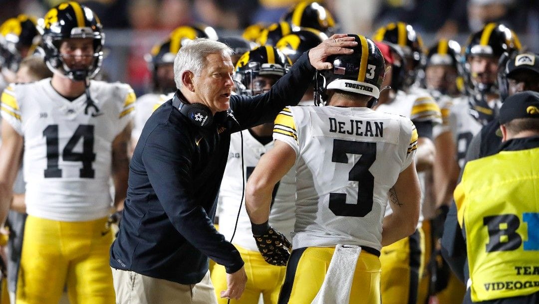 Iowa head coach Kirk Ferentz congratulates Iowa defensive back Cooper DeJean (3) after scoring a touchdown against Rutgers during the first half of an NCAA football game, Saturday, Sept. 24, 2022, in Piscataway, N.J.