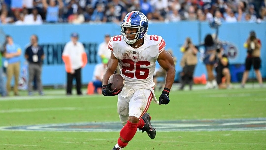 New York Giants running back Saquon Barkley (26) carries the ball against the Tennessee Titans in the second half of an NFL football game Sunday, Sept. 11, 2022, in Nashville, Tenn.