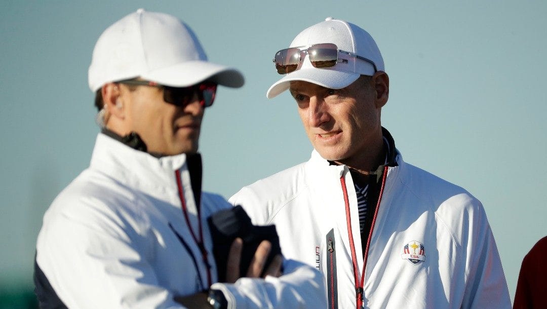 U.S. team captain Jim Furyk, right, stands alongside vice-captain Zach Johnson on the driving range at Le Golf National in Guyancourt, outside Paris, France, Tuesday, Sept. 25, 2018.