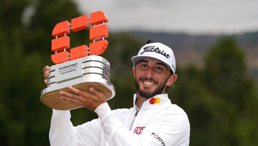 Max Homa raises his trophy on the 18th green of the Silverado Resort North Course after winning the Fortinet Championship PGA golf tournament in Napa, Calif., Sunday, Sept. 18, 2022.