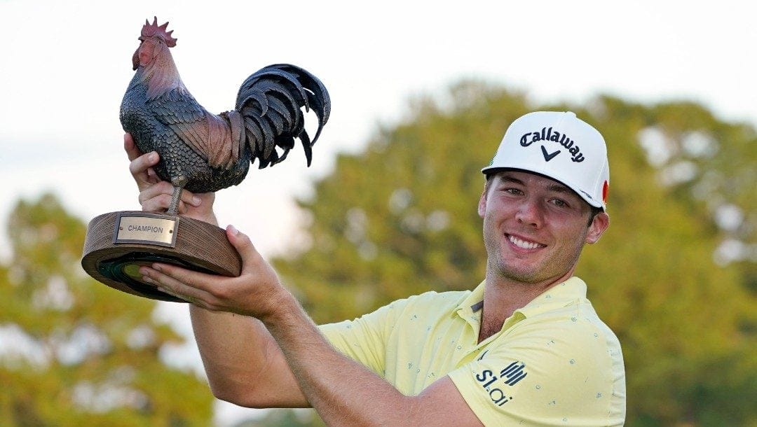 Sam Burns holds the champion's trophy after winning the Sanderson Farms Championship golf tournament in Jackson, Miss., Sunday, Oct. 3, 2021.