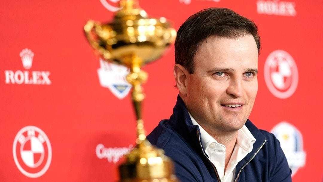 Zach Johnson sits next to the Ryder Cup trophy after being named the 2023 United States Ryder Cup golf captain at PGA of America headquarters, Monday, Feb. 28, 2022, in Palm Beach Gardens, Fla.