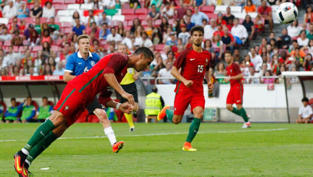 Portugal's Cristiano Ronaldo heads the ball to score against Estonia.