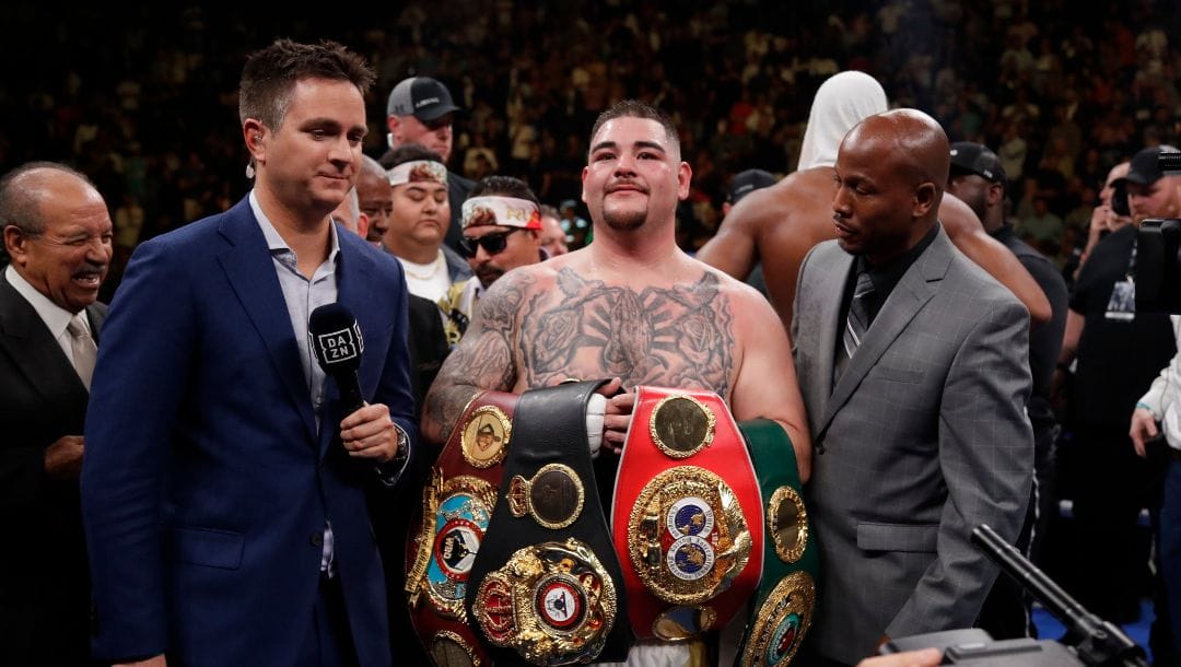 Andy Ruiz poses for photographs after a heavyweight championship boxing match against British boxer Anthony Joshua.