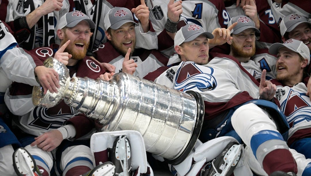 Colorado Avalanche team members pose with the Stanley Cup after defeating the Tampa Bay Lightning in Game 6 of the NHL hockey Stanley Cup Finals on Sunday, June 26, 2022, in Tampa, Fla. (AP Photo/Phelan M. Ebenhack)