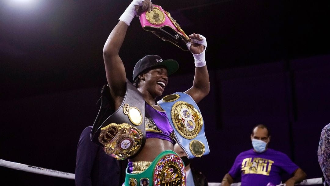 Claressa Shields holds her championship belts after defeating Marie-Eve Dicaire by decision.