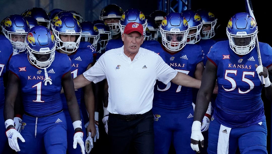 Kansas head coach Lance Leipold leads his team onto the field before an NCAA college football game against Tennessee Tech Friday, Sept. 2, 2022, in Lawrence, Kan. (AP Photo/Charlie Riedel)