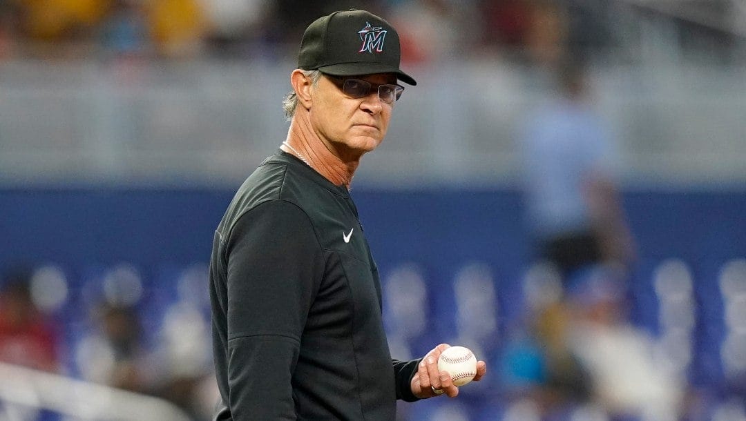 Miami Marlins manager Don Mattingly stands on the field after a pitching change during the fourth inning of a baseball game against the Washington Nationals, Sunday, Sept. 25, 2022, in Miami.
