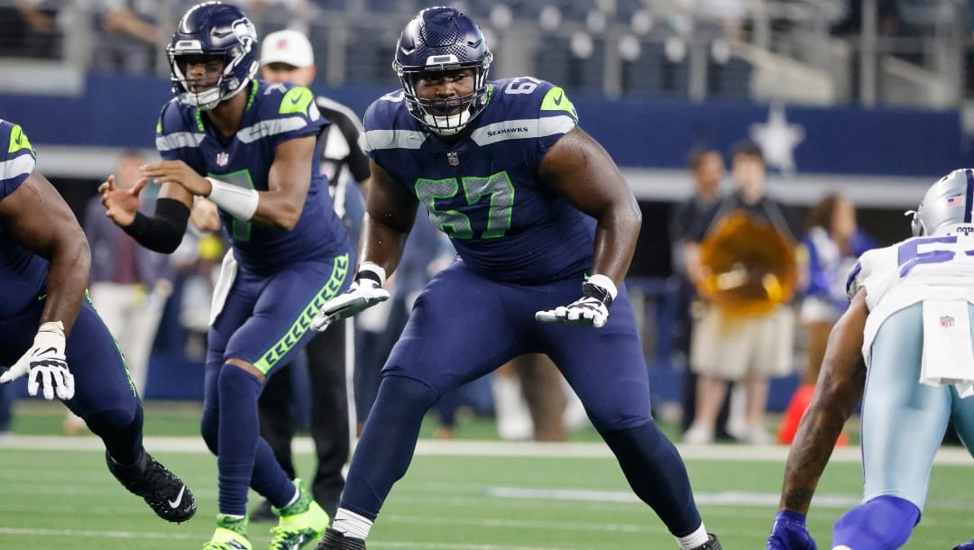 Seattle Seahawks offensive tackle Charles Cross (67) prepares to block